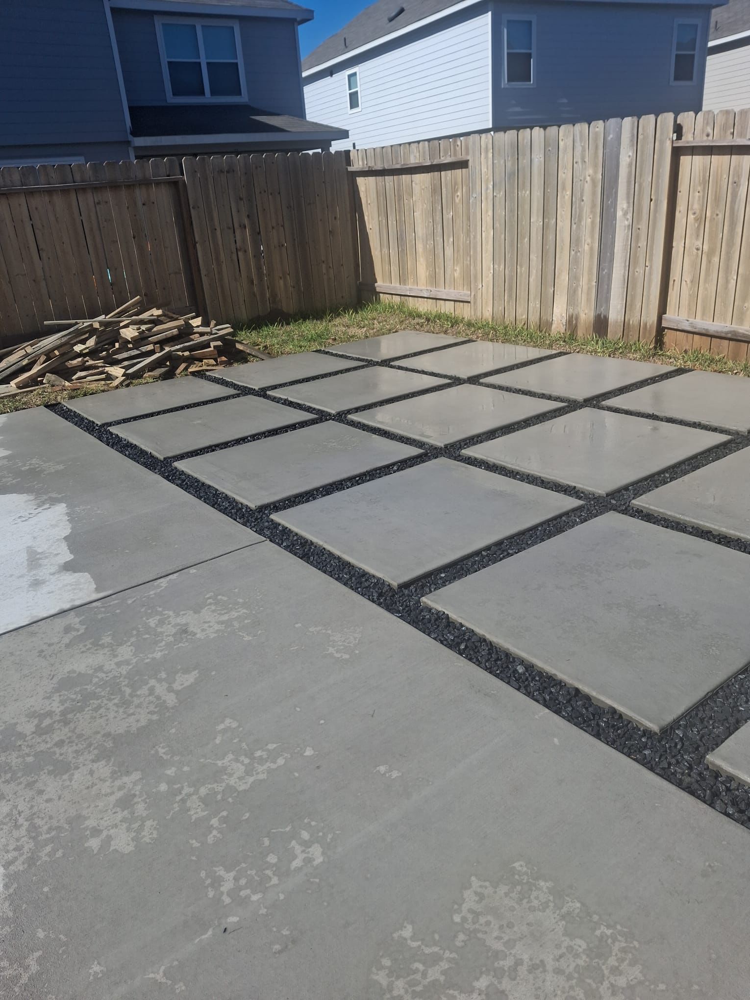 concrete patio in backyard with fenced in yard
